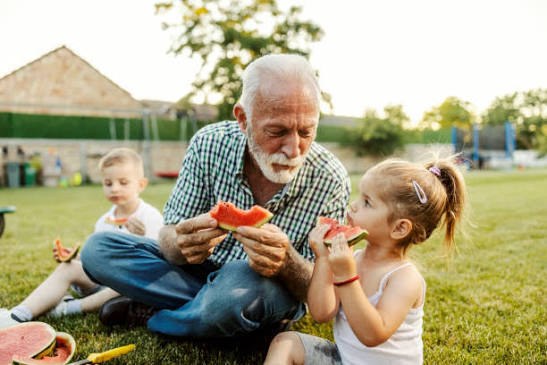 Grandparents and grandchildren sharing a family picnic