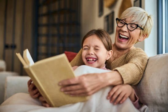 Grandmother and granddaughter reading together