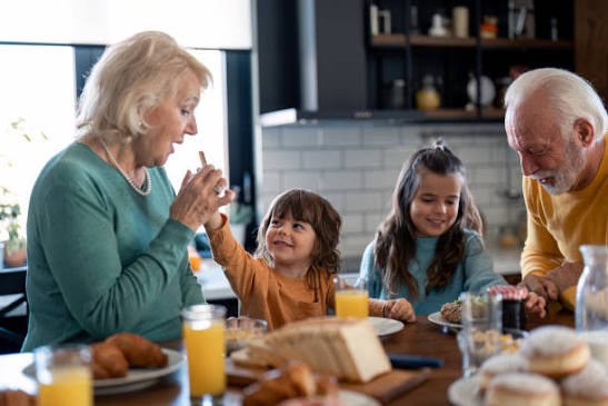 Grandparents and grandchildren sharing breakfast together